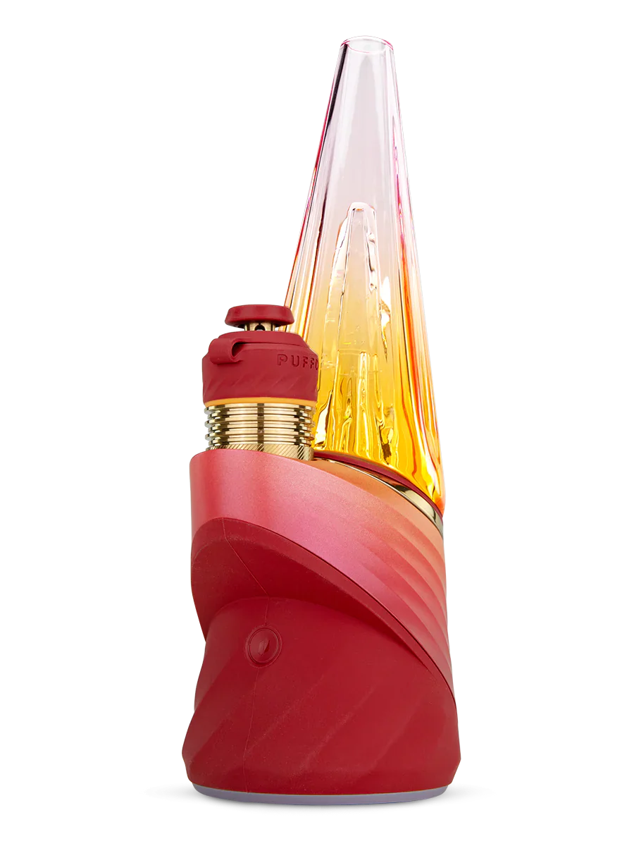A red and gold electronic device with a pointed top and a red cap, set against a black background.