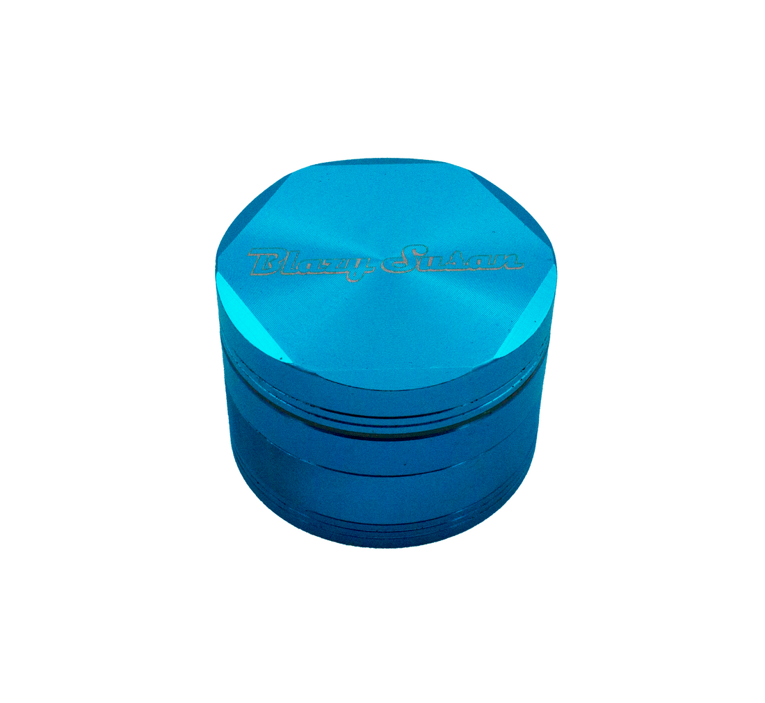 A blue grinder with a silver mesh inside, placed on a white background.