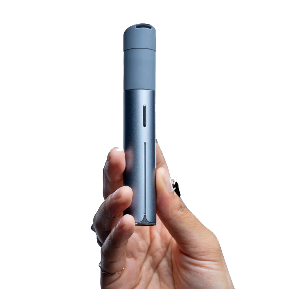A person's hand holding a small, gray electronic device.