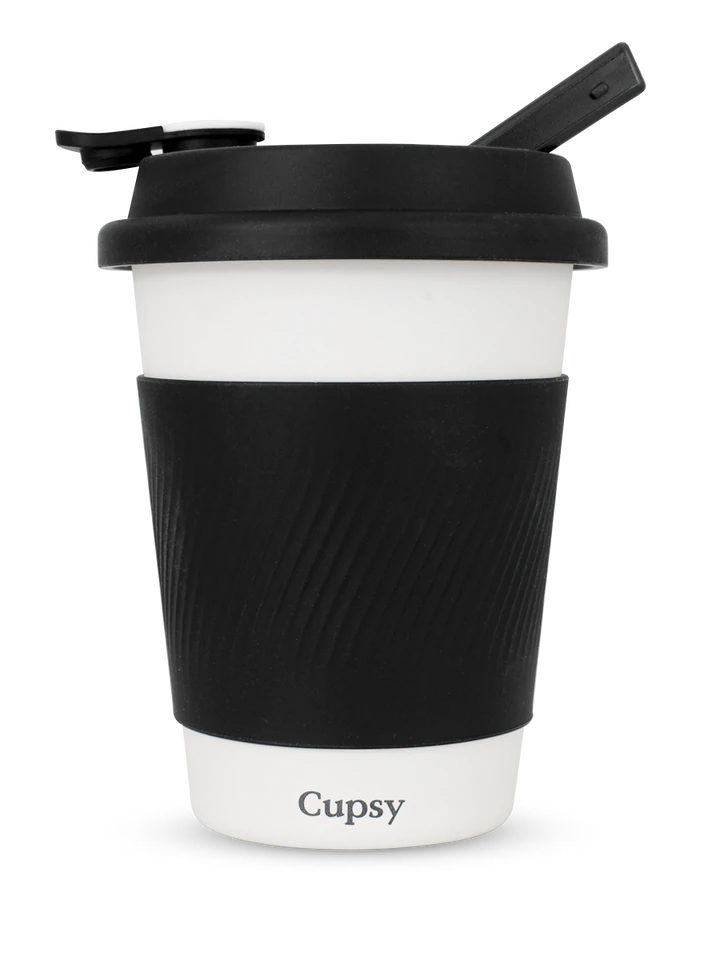 A black and white coffee cup with a textured surface and a black lid.