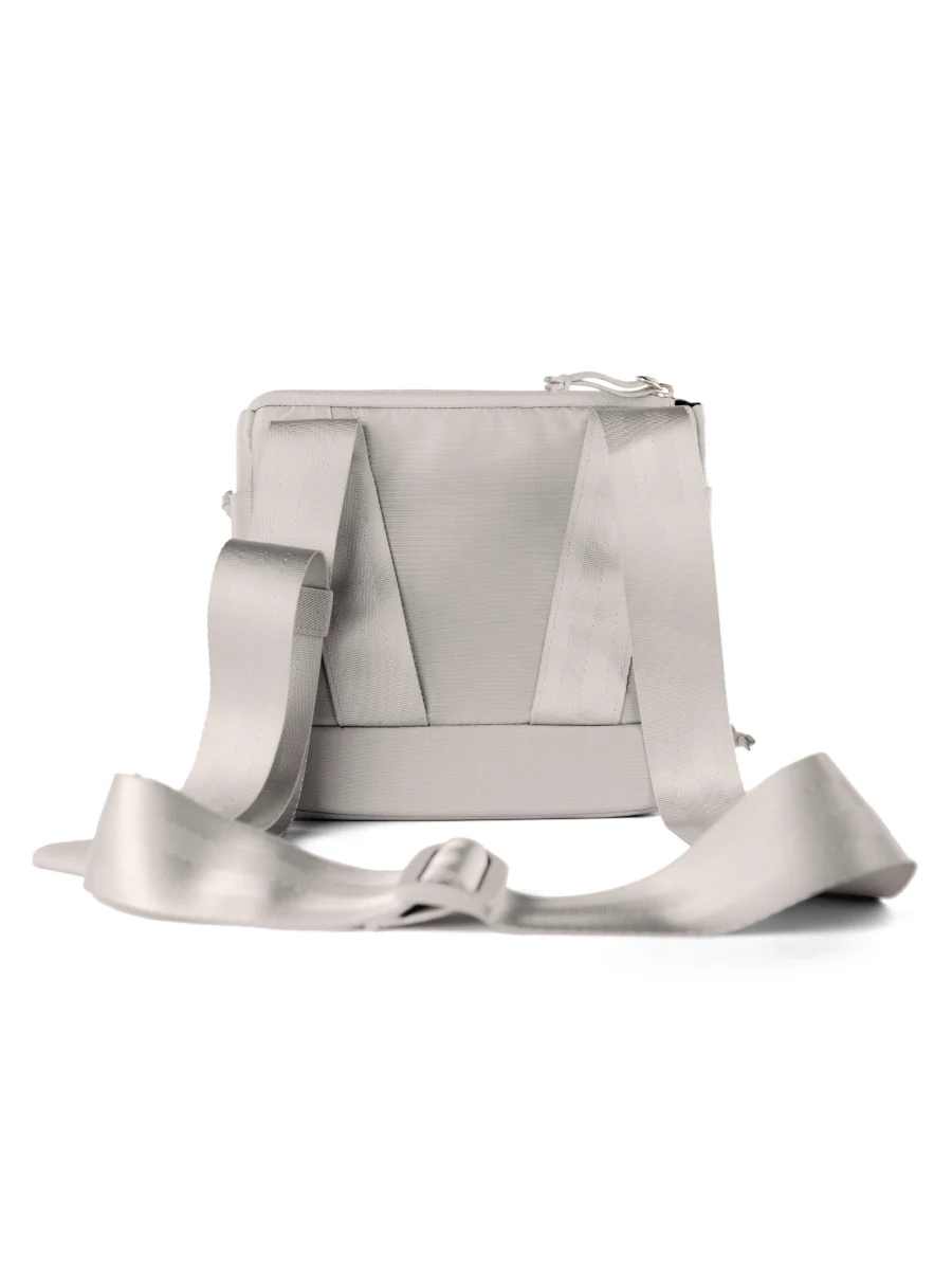 A gray satchel with a strap and a zipper closure.
