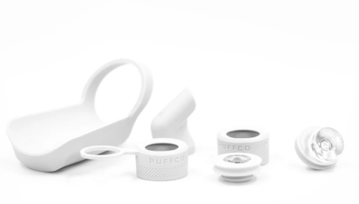 several white objects, including a cup, a ring, and some other items, all placed against a white background.