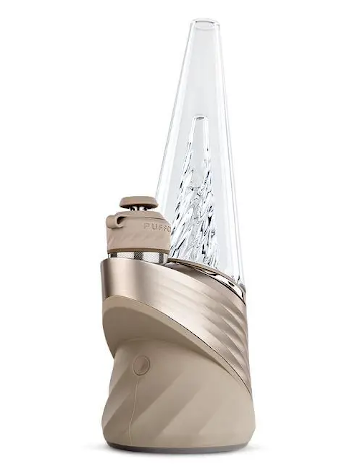 A beige electronic device with a clear glass tube and a small white cap on top, sitting on a white surface.