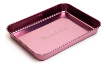 A rectangular, metallic, pink-colored baking tray with the text "Blazzy Susan" printed on it.
