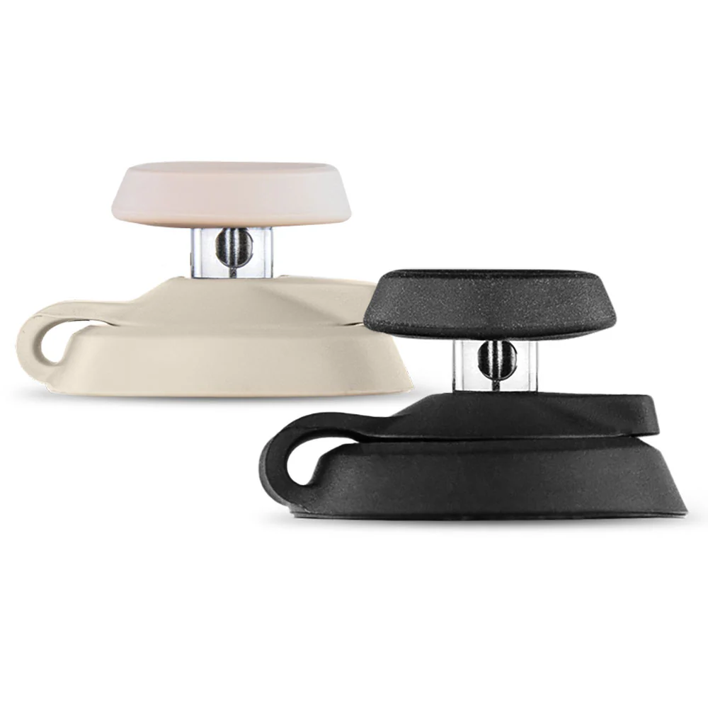 two black and beige objects, possibly a black and beige lamp or a black and beige desk lamp, placed side by side against a white background.
