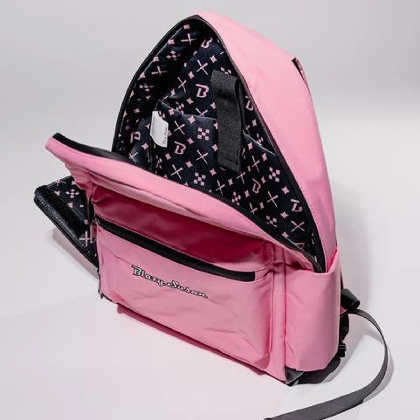 A pink backpack with a black pattern inside, featuring the text "Blueson" on the front.