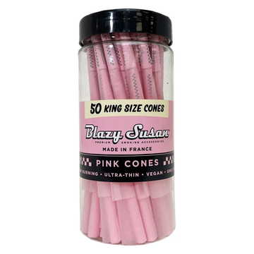 A clear glass jar filled with pink-colored rolling papers, labeled as 50 king size cones.
