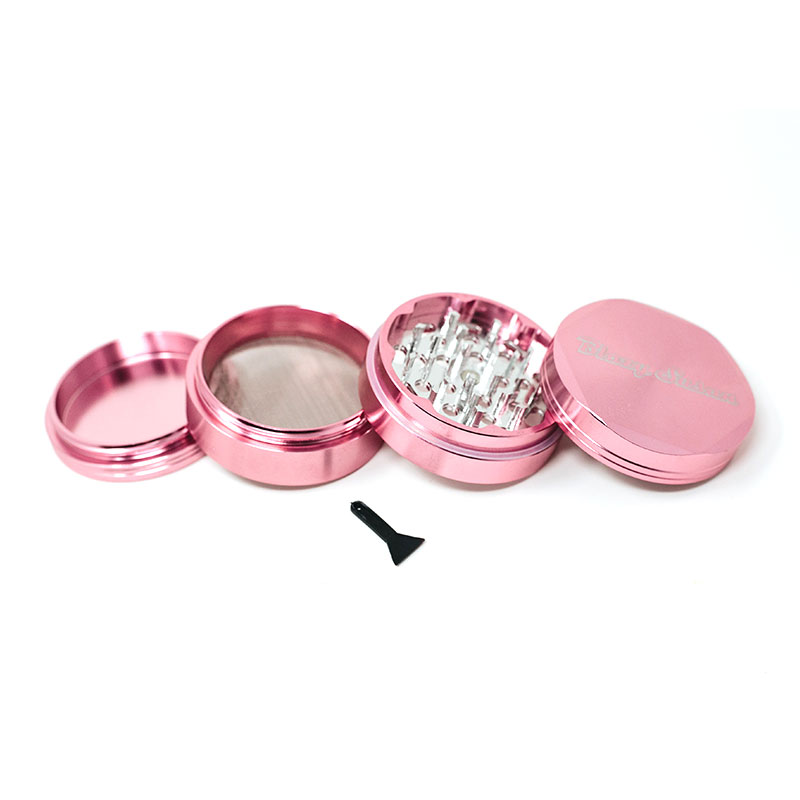 A pink grinder with a black tool on a white background.