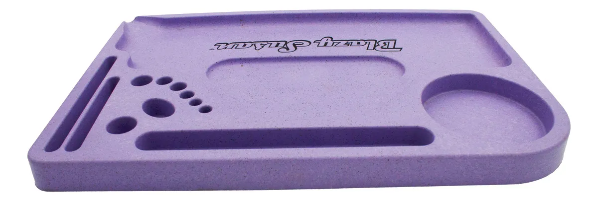 A purple tray with various compartments and holes, designed for organizing and storing items.