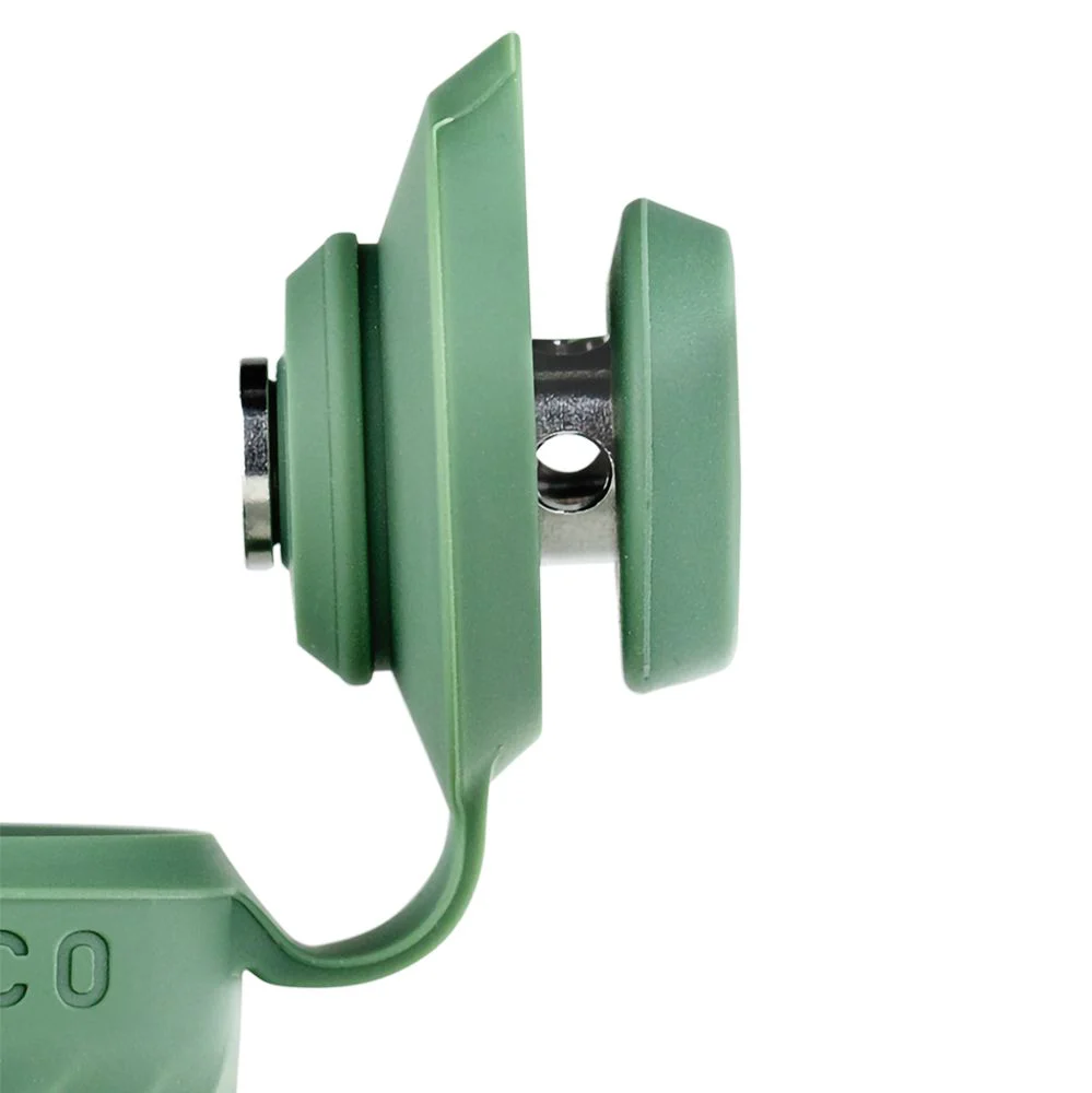 A close-up view of a green plastic object with a curved shape, possibly a piece of furniture or a tool.