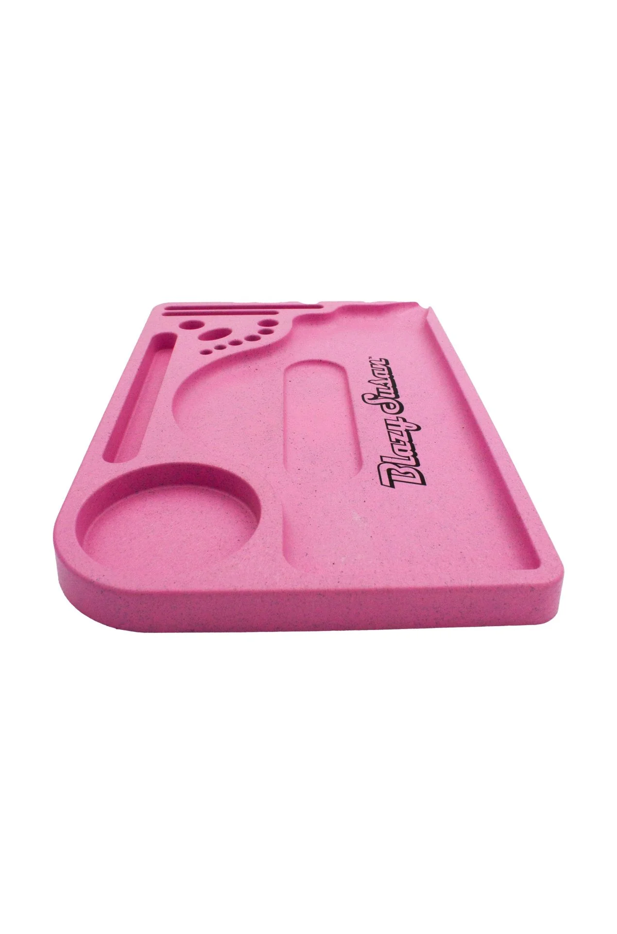 A pink, rectangular tray with various holes and compartments.