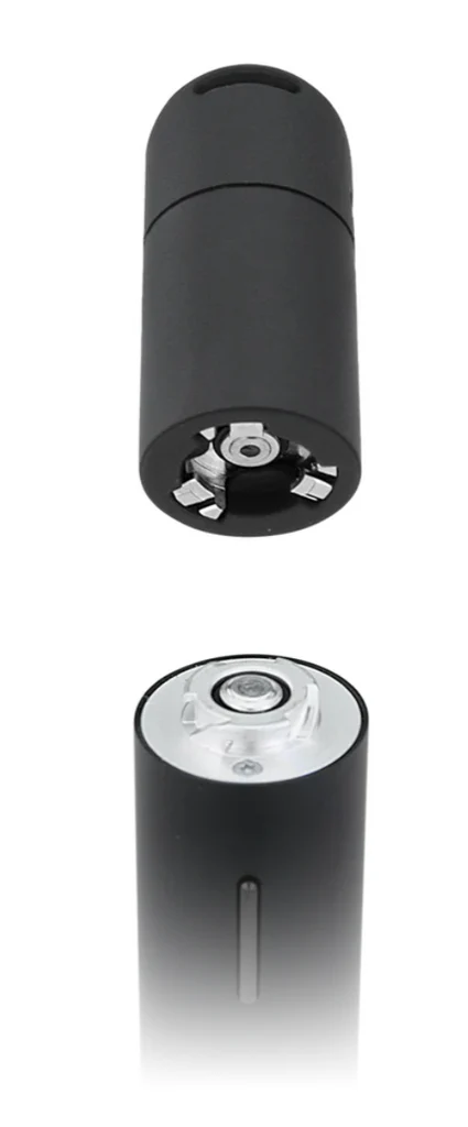 a black cylindrical object with a clear circular opening at the top, which appears to be a device or tool.