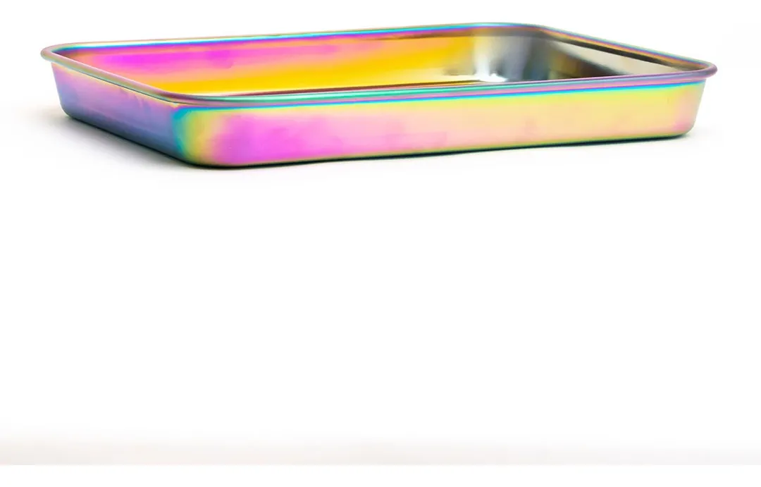 A metallic, rainbow-colored container or tray with a metallic sheen, sitting on a white surface.