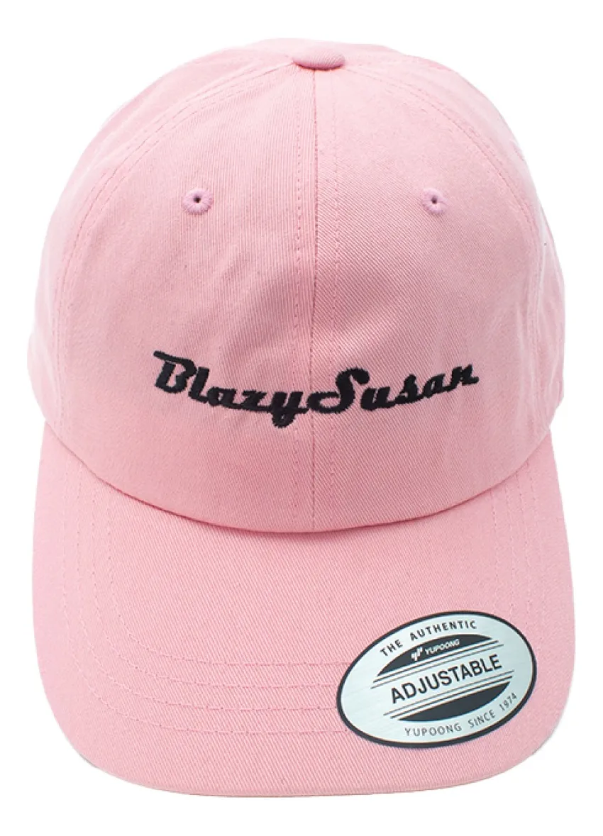 A pink baseball cap with the name "Blazys Susan" printed on it in black text.