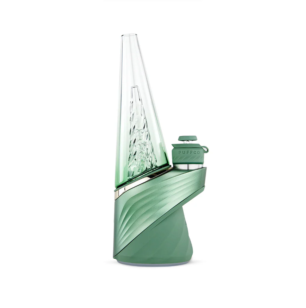 A green electronic device with a pointed top and a clear glass tube, possibly a piece of electronic equipment or a decorative item.