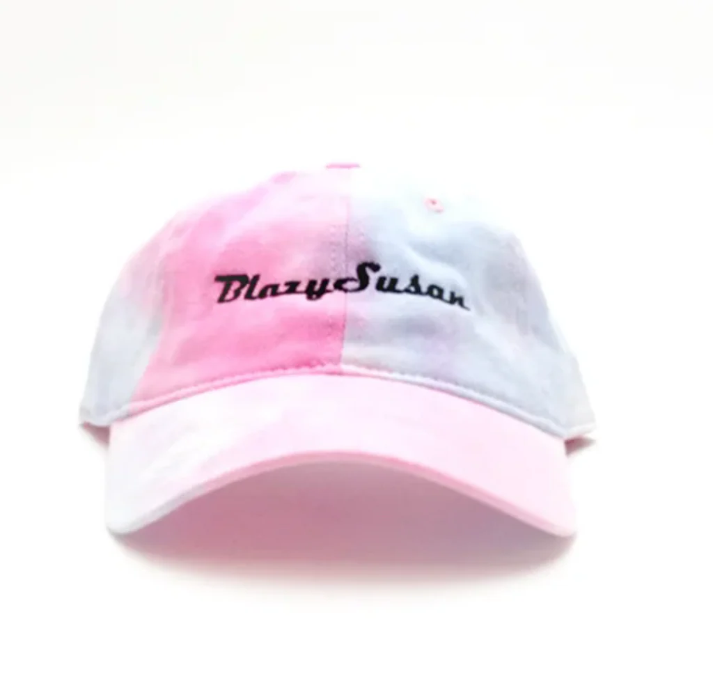 A pink and white baseball cap with the name 'Blazys Susan' printed on it.