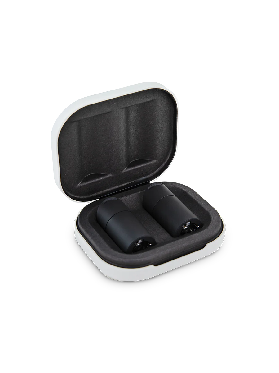 A white and black case containing two black electronic devices, likely headphones or earbuds, is shown against a black background.
