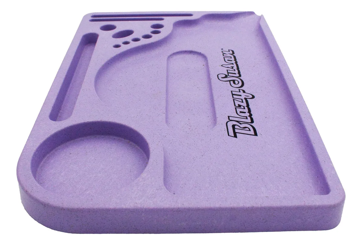 A purple, rectangular tray with various holes and compartments, designed for holding and organizing small items.