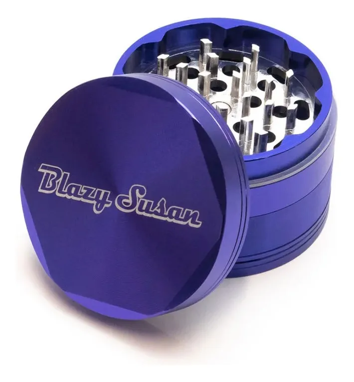 A purple metal grinder with a lid, containing multiple silver-colored grindstones.