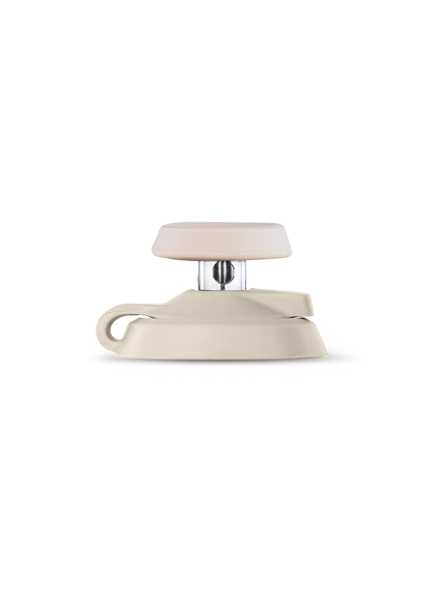 A white, beige, and silver object is shown against a black background.