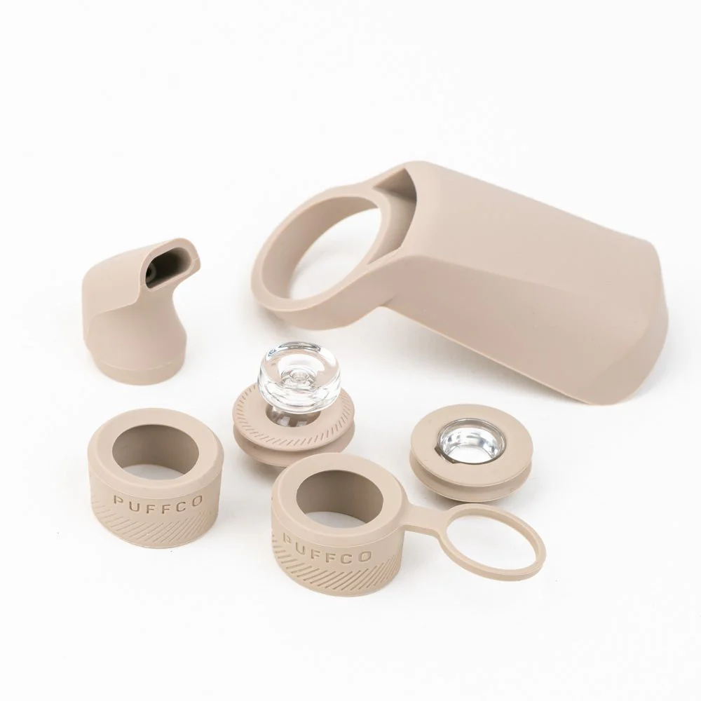 A modern, sleek electronic device with a clear glass body and a beige color scheme.