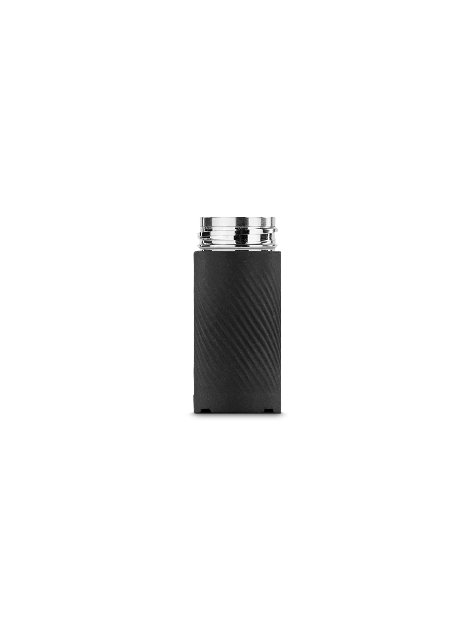 A cylindrical object with a metallic top is shown against a black background.