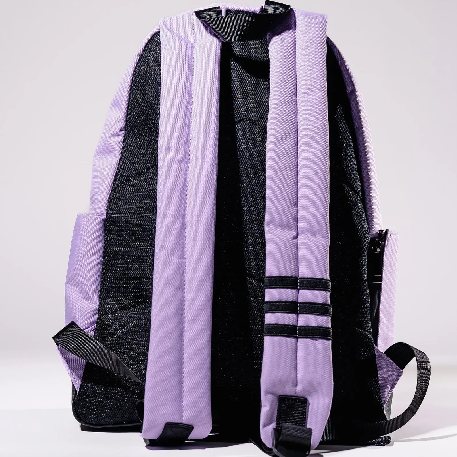 A purple backpack with black straps and mesh panels.