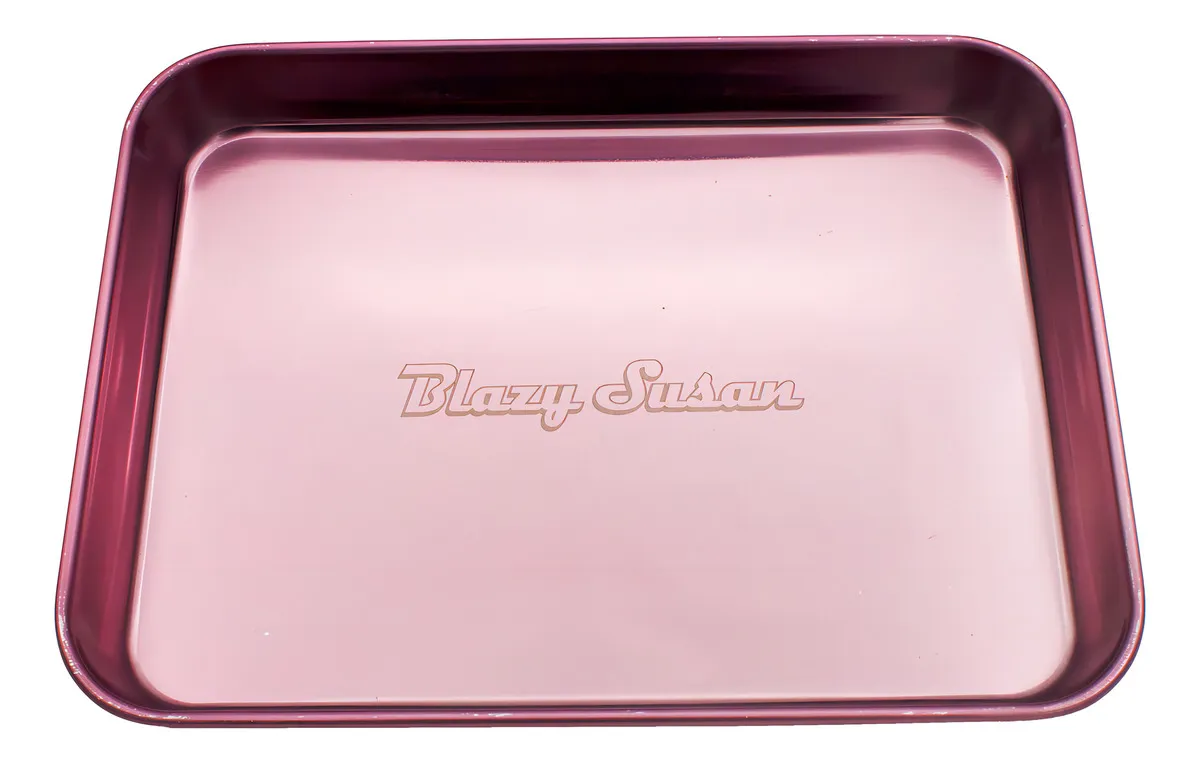A pink metal cookie sheet with the text "Blazy Susan" engraved on it.