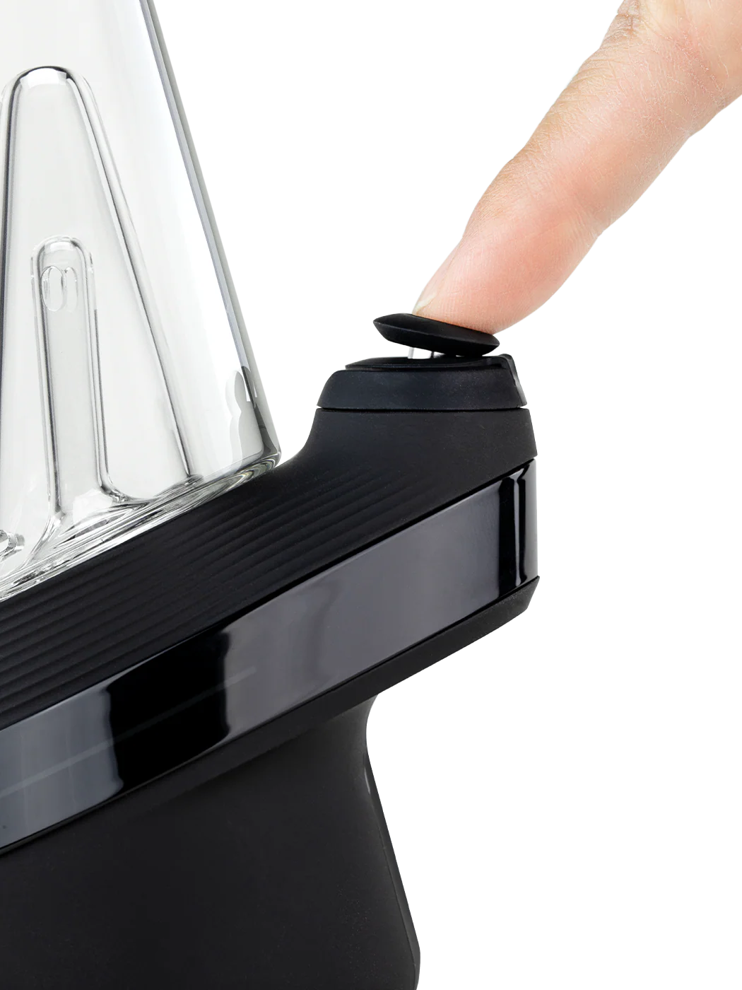 A person's thumb is pressing a button on a black blender with a clear plastic container.